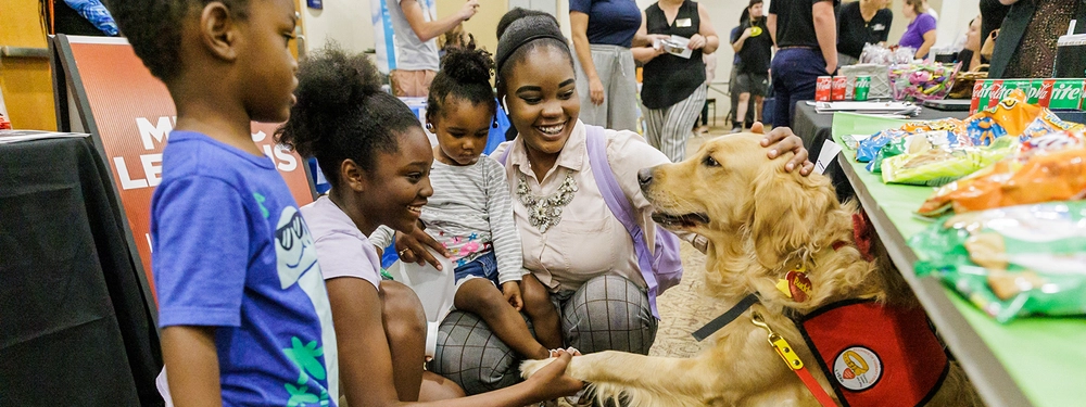 Children meeting a therapy dog.