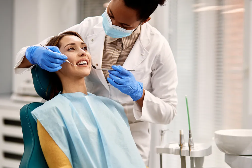 A dental hygienist working on a patient