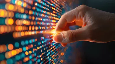 a hand touching a screen of code