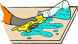 Illustrated image of a spilled beaker on a table and someone wearing gloves cleaning it with a yellow cloth
